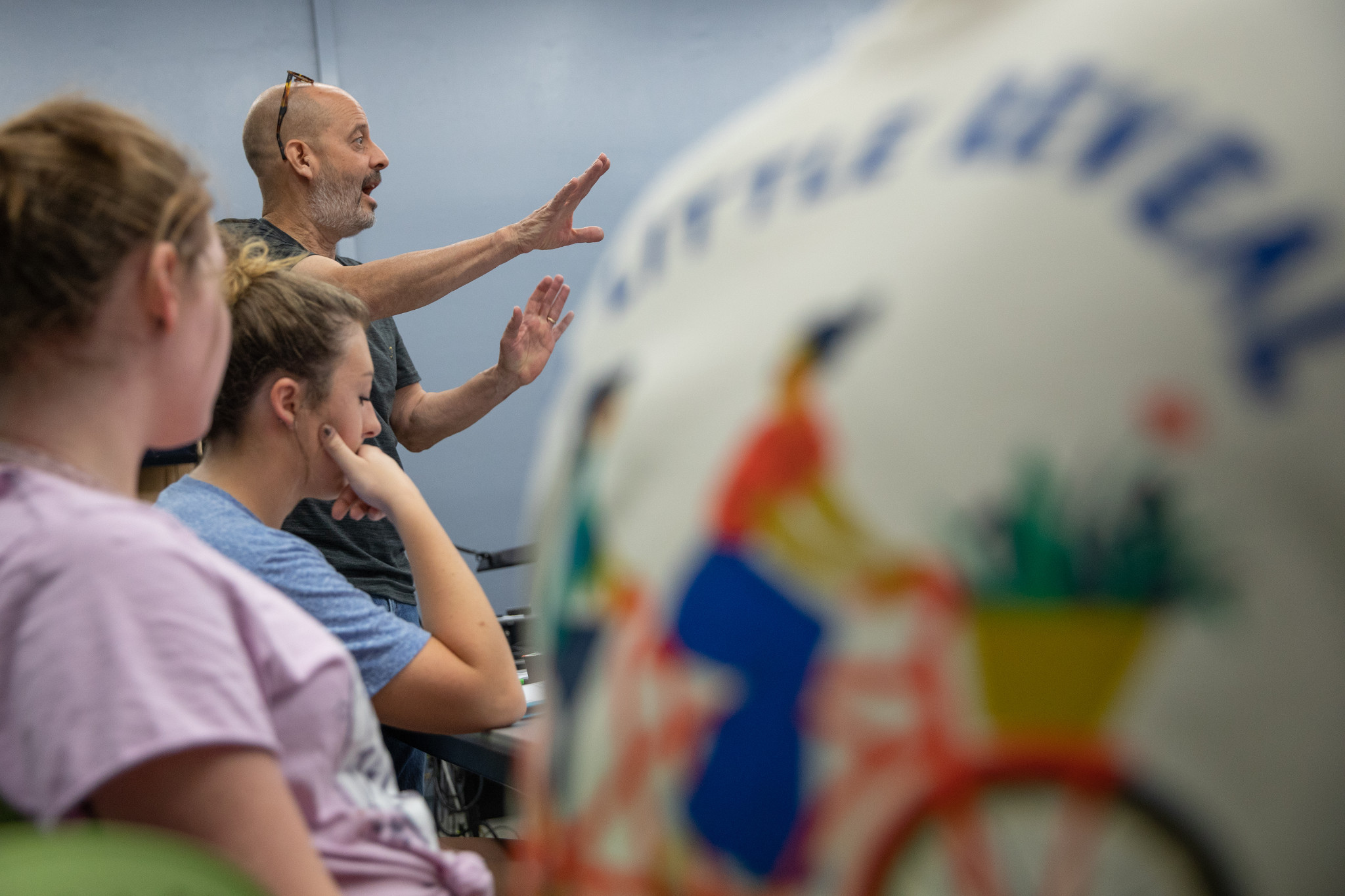 Professor lecturing to a classroom of students.
